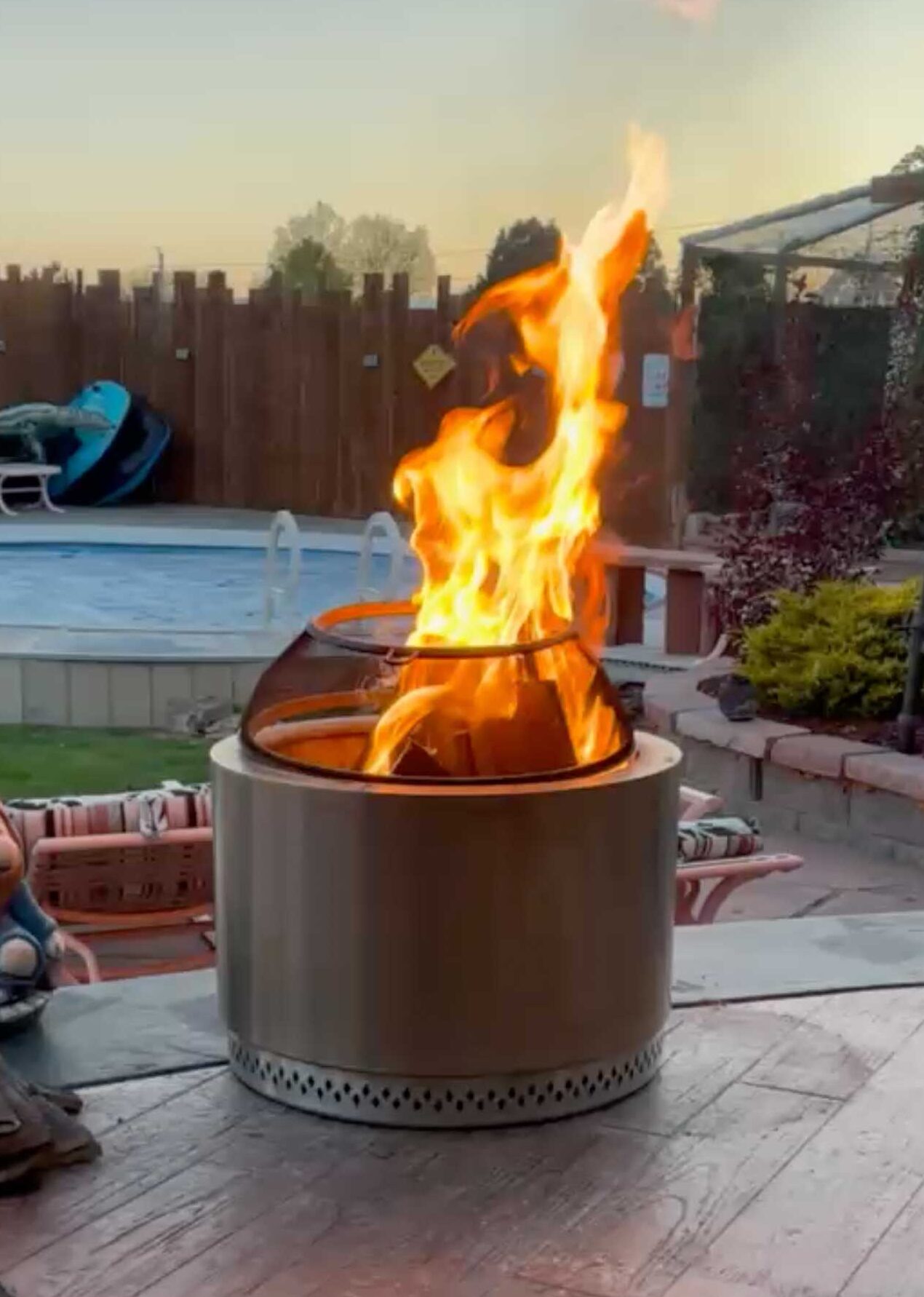 fire pit flame with pool in background